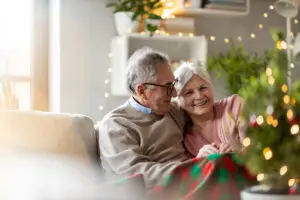 Senior couple sitting in the living room together during Christmas